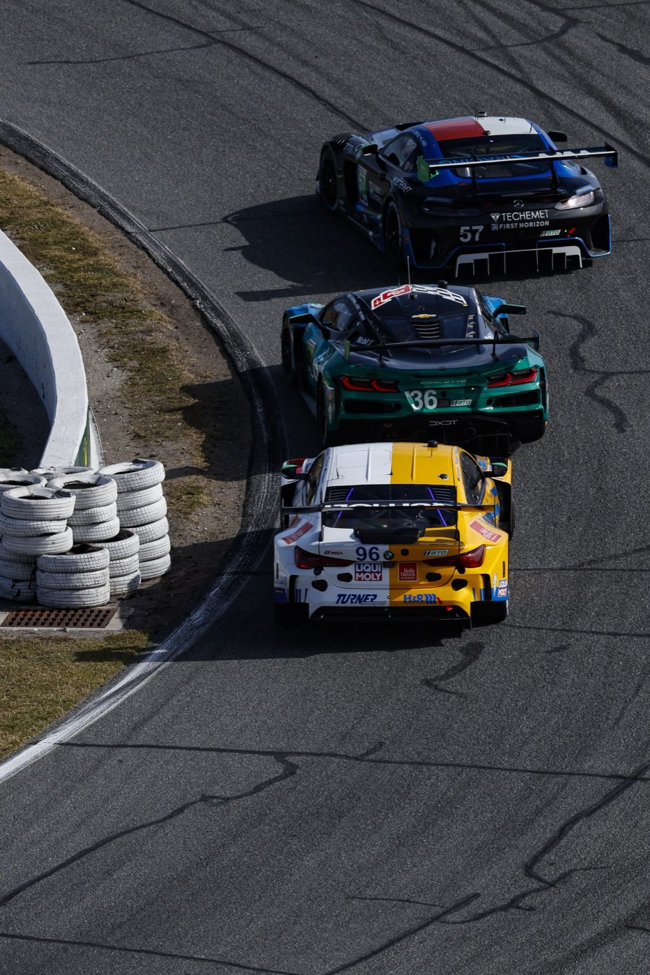 The #96 BMW M4 GT3 EVO racing in GTD traffic at Daytona
